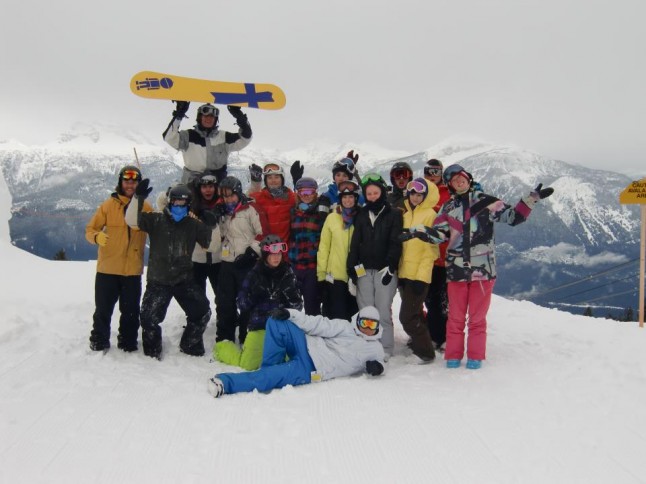 a group of skiers in gear at the top of a mountain in Canada